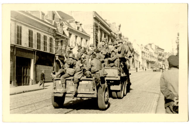 Soldats américains remontant la rue d’Isle à Saint-Quentin à bord d’un véhicule militaire en septembre 1944